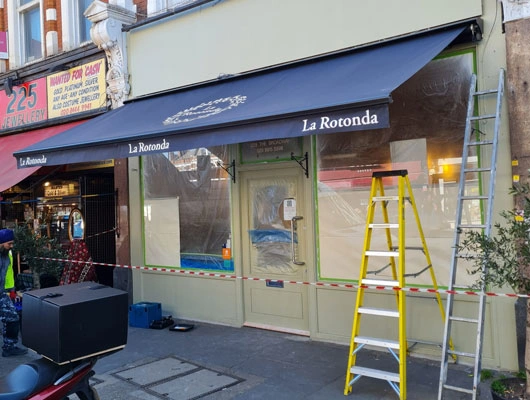 Commercial awning installed over a cafe storefront